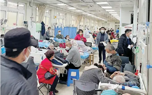  ?? — reuters ?? Patients lie in the emergency department of a hospital amid a Covid outbreak in Shanghai on Wednesday.