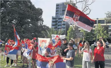  ?? REUTERS ?? People rally in support of tennis
star Novak Djokovic in Melbourne yesterday.