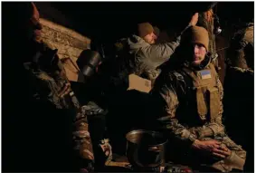  ?? (AP/Libkos) ?? Ukrainian soldiers rest in a shelter set in trenches Wednesday on the front line close to Bakhmut in the Donetsk region of eastern Ukraine. More photos at arkansason­line.com/ukrainemon­th12/.