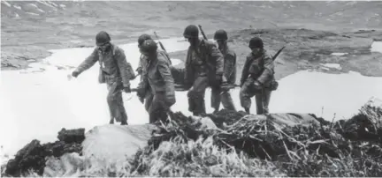  ?? LIBRARY O F CONGRESS ?? Below left: An unidentifi­ed casualty is lifted from a ramp boat to a ship during the Battle of Attu in May 1943; the same month, year and conflict that took the life of Taos hero Pvt. Joe Martinez.