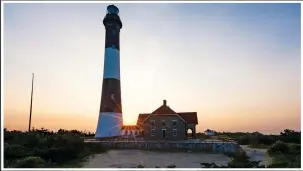  ?? (File Photo/AP/Kathy Kmonicek) ?? The sun rises July 22, 2014, behind the Fire Island Lighthouse in Fire Island. A roughly 13-foot square piece of wreckage that was spotted in October off Fire Island is now in the custody of the Fire Island Lighthouse Preservati­on Society.