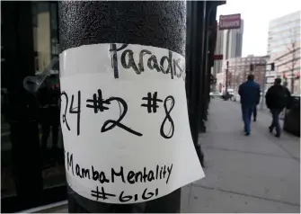  ?? NANCY LANE / BOSTON HERALD ?? SOLEMN SIGN: A sign honoring Kobe Bryant is taped to a pole on Causeway Street near the TD Garden on Monday. Bryant had both the nubers 8 and 24 retired as a Laker, from two stints he did with the team wearing those numbers. The number 2 is in honor of Bryant’s daughter, Gianna, 13, who was also killed in the helicopter crash and who wore the number 2 when she played.