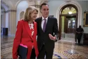  ?? J. SCOTT APPLEWHITE — THE ASSOCIATED PRESS ?? Republican Senators Lisa Murkowski of Alaska and Mitt Romney of Utah greet each other at the Capitol in Washington on April 5.