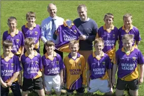  ??  ?? Ger Whitty of Whitford House Hotel presenting the Murrintown N.S. Rackard League hurling team and their mentor, Johnny Murphy, with a new set of jerseys.
