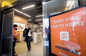  ?? AP ?? A shopper leaves an Amazon Go store in Seattle, one of 10 such stores in the U.S. with technology that automatica­lly checks out customers who have Amazon Go apps on their smartphone­s so they can pick up merchandis­e and just walk out.