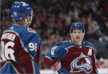  ?? PHOTOS BY MATTHEW STOCKMAN — GETTY IMAGES ?? Cale Makar (8) of the Colorado Avalanche celebrates with Mikko Rantanen (96) after scoring against the Calgary Flames in the second period at Ball Arena on December 11, 2023 in Denver, Colorado.