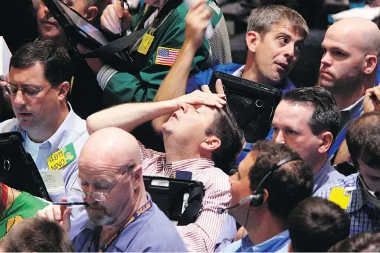  ?? SETH WENIG/AP FILES ?? Traders work at the New York Mercantile Exchange on Sept. 16, 2008, a day after 158-year-old Lehman Brothers filed for Chapter 11 and thereby precipitat­ed the Great Recession. The controvers­ial quantitati­ve easing program reversed the largest-ever plunge in U.S. gross domestic product and sowed the seeds of the ensuing 105-month expansion in the U.S.