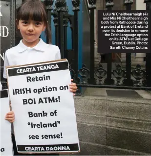  ?? Photo: Gareth Chaney Collins ?? Lulu Ní Cheithearn­aigh (4) and Mia Ní Cheithearn­aigh both from Rathcoole during a protest at Bank of Ireland over its decision to remove the Irish language option on its ATM’s at College Green, Dublin.