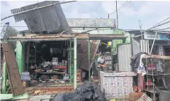  ?? AFP ?? A man cleans his shop yesterday after Cyclone Bulbul hit the area in Bakkhali, India late on Saturday.