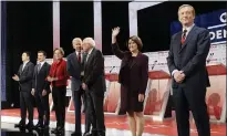  ?? CHRIS CARLSON — AP ?? Democratic presidenti­al candidates from left, Andrew Yang, South Bend Mayor Pete Buttigieg, Sen. Elizabeth Warren, D-Mass., former Vice President Joe Biden, Sen. Bernie Sanders, I-Vt., Sen. Amy Klobuchar, D-Minn., and Tom Steyer stand onstage at the debate.