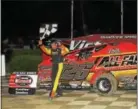  ?? SUBMITTED PHOTO - RICH KEPNER ?? Jeff Strunk carries the checkered flag after his win Saturday night at Grandview Speedway.