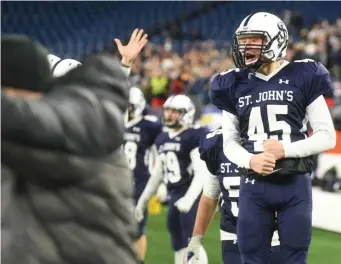  ?? JEFF PORTER / BOSTON HERALD ?? FLYING EAGLES: Jarrett Young celebrates on the sideline during St. John’s Prep’s victory against Catholic Memorial in last night’s Division 1 Super Bowl at Gillette Stadium.