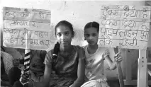  ??  ?? Two girls of Sawda Ghevra hold placards that read, ‘Stop this torture. The government should install water pipeline in Sawda Ghevra’ and ‘We pay taxes. We’ll get our pipeline, too’.