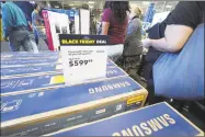  ?? Getty Images ?? Consumers shop Black Friday sales at the Best Buy store in Burbank, Calif., last year.