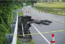  ?? Delia Johnson/ Post- Gazette ?? A landslide obstructs Camp Meeting Road in Bell Acres on Friday.