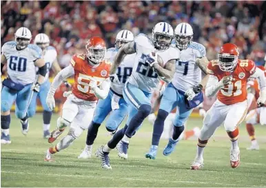  ?? CHARLIE RIEDEL/AP ?? Titans running back Derrick Henry (22) rumbles for a 35-yard touchdown past Chiefs defenders during the second half of Saturday’s NFL wild-card playoff game in Kansas City.