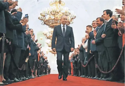 ?? POOL PHOTO BY ALEXANDER ZEMLIANICH­ENKO ?? Vladimir Putin enters his inaugurati­on ceremony as Russia’s president in 2018, where he took the oath for his fourth term. Opposition leaders have long cited corruption claims.