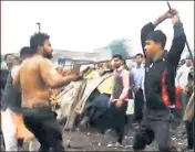  ?? SOURCED ?? A screenshot of the video shows a mob beating up a man with sticks in outer Delhi's Kirari.