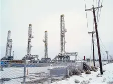  ?? MATTHEW BUSCH/BLOOMBERG ?? Oil drilling rigs sit idle in the snow at a lot Saturday near Midland, Texas.