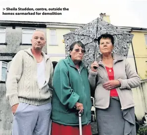  ??  ?? Sheila Studden, centre, outside the homes earmarked for demolition