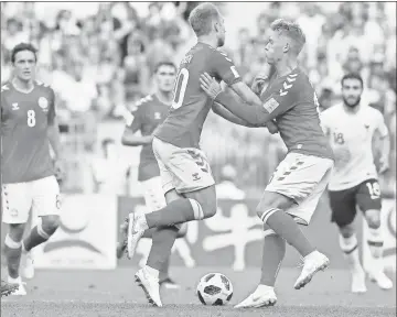  ?? / AP - David Vincent ?? Danish teammates Christian Eriksen (left) and Viktor Fischer collide during Tuesday’s match against France. The two European nations played to a scoreless draw, though both advanced.