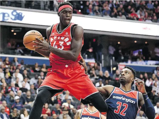  ?? NICK WASS / THE ASSOCIATED PRESS ?? Toronto Raptors forward Pascal Siakam leaps up with the ball against Washington Wizards forward Jeff Green, during NBA action Saturday in Washington. Siakam had 10 points and 10 rebounds coming off the bench in a 117-113 win over the Wizards.