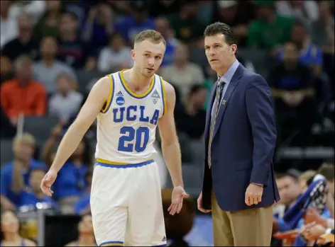  ?? AP PHOTO ?? UCLA coach Steve Alford talks with his son, guard Bryce Alford, during the first half of a first-round game against Kent State in the men’s NCAA college basketball tournament in Sacramento on Friday.