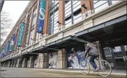  ?? ASSOCIATED PRESS ?? A bicyclist rides past T-Mobile Park in Seattle, where the Mariners might not play again until deep into the summer due to the COVID-19 coronaviru­s.