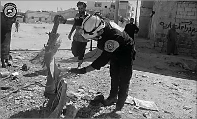  ?? Associated Press ?? Members of Civil Defense inspect a cluster bombs in the Khan Sheikhoun neighborho­od of Idlib on Thursday in Syria.