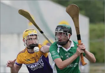  ??  ?? Faythe Harriers defender Stephen Cummins attempts to block Lorcan Leacy (Crossabeg-Ballymurn).