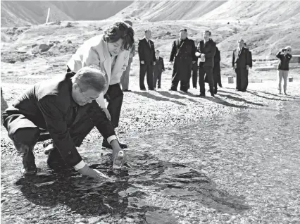  ??  ?? South Korean President Moon Jae-in (left) and his wife Kim Jung-sook fill a bottle with water from the Heaven Lake on the top of Mount Baektu in the Democratic People’s Republic of Korea yesterday. DPRK leaderKim Jong Un also joined Moon during the visit to the spiritual birthplace of the Korean nation. — AFP