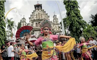  ??  ?? Indonesian Catholic dancers at a Christmas celebratio­n in Bali, where Kiwis are increasing­ly going for rest and relaxation at Christmas.