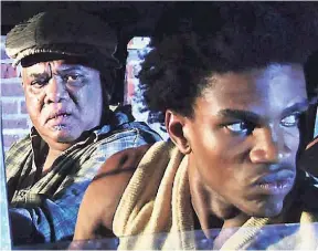  ??  ?? Actors Volier Johnson (left) and Sheldon Sheperd in a scene from the movie, ‘Better Mus’ Come’.