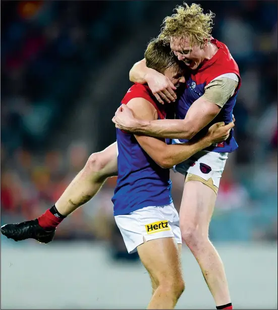  ??  ?? James Jordon pictured celebratin­g a goal with best mate Clayton Oliver. Photo: AAP.