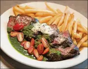  ??  ?? Steak Frites with french fries, compound butter and bacon chimichurr­i sauce.