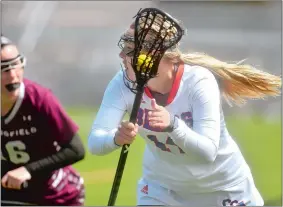  ?? TIM MARTIN/THE DAY ?? Coast Guard Academy’s Daria McKenna, right, attempts to get past Springfiel­d defender Amanda Picozzi during Saturday’s 17-6 loss in New London. McKenna, a senior from Fitch High School, is closing in on 100 career points for the Bears.