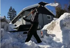  ?? Photograph: Mario Tama/Getty Images ?? A resident shovels snow after a series of winter storms dumped heavy snowfall in southern California.