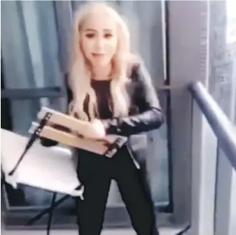  ??  ?? A video image of a woman who allegedly tossed a chair off the balcony of a downtown Toronto highrise. Marcella Zoia was charged with mischief endangerin­g life.