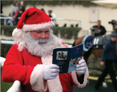  ?? STEVE PARSONS/PA WIRE ?? Santa Claus checking the card at Ascot yesterday as he takes a well-earned break from his busy schedule