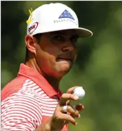  ?? CHARLIE RIEDEL AP PHOTO BY ?? Gary Woodland holds his ball after making a birdie on the third hole during the second round of the PGA Championsh­ip golf tournament at Bellerive Country Club, Friday, Aug. 10, in St. Louis.