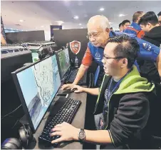  ??  ?? Prime Minister Datuk Seri Najib Tun Razak with one of the participan­t during the Malaysia Cyber Games 2018 (MCG18) at Putra World Trade Centre (PWTC). — Bernama photo