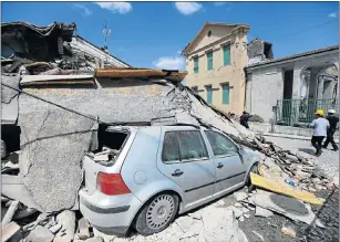  ?? Picture: BLOOMBERG ?? IN RUINS: Rubble rests on top of a car following an earthquake in Amatrice, central Italy, on Wednesday.