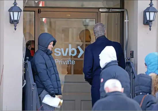  ?? MATT STONE — BOSTON HERALD ?? Customers wait in line outside the Silicon Valley Bank just before the FDIC closed it on Friday in Wellesley.