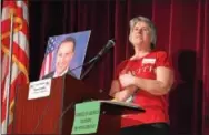  ?? DIGITAL FIRST MEDIA FILE PHOTO ?? Tammy Harkness, an organizer of a Feb. 25 town hall meeting at Phoenixvil­le Area High School, stands next to a photo of U.S. Rep. Ryan Costello, R-6, who was invited to the meeting but could not attend because of scheduling conflicts. The school board...