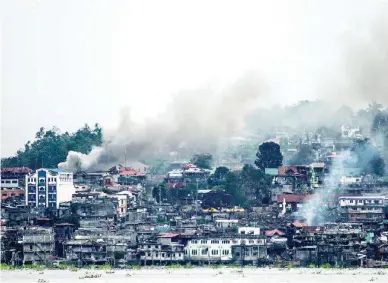  ??  ?? WAR RAVAGED – Packets of smoke rise from areas hit by airstrikes by the Philippine Air Force in this photo taken from Lake Lanao, Saturday. (Contribute­d by Linus Guardian Escandor II)