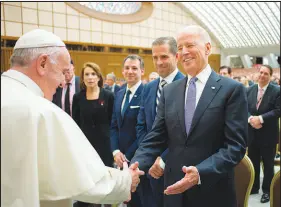  ?? PABLO MARTINEZ MONSIVAIS /L’OSSERVATOR­E ROMANO / POOL PHOTO VIA AP ?? Pope Francis shakes hands with then-vice President Joe Biden in 2016 at the Vatican. Biden, now president, is scheduled to meet today with Francis at the Vatican.
