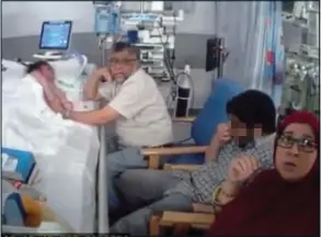  ??  ?? In a bedside vigil with his wife Aliya and another relative, Rashid is gently stroking his dying daughter’s arm when police enter the ward