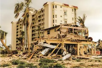  ?? FILE ?? Homes and condominiu­ms damaged by Hurricane Ian in Fort Myers Beach on Feb. 9. Communitie­s like Fort Myers Beach, Sanibel and Captiva, devastated by the storm, are struggling to rebuild the hotel rooms, restaurant­s and rental units that keep their economies alive.