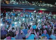  ??  ?? Fans shine their smartphone lights and take photos as Irish rockers U2 perform the final stop of the U.S. leg of their eXPERIENCE + iNNOCENCE tour Tuesday at Mohegan Sun Arena.