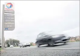  ?? BOB EDME — THE ASSOCIATED PRESS FILE ?? Cars pass by a gas station in Saint Jean de Luz, southweste­rn France, on Friday.